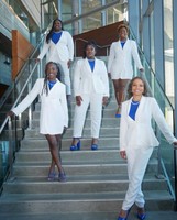 Sorority sisters standing on the steps inside Claire T Carney library