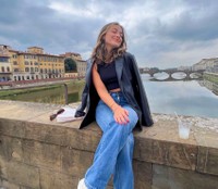 Mabel Ferreira seated on a bridge in Florence, Italy