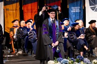 Riley is hooded at the 2026 commencement ceremony.