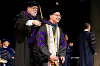 Sean Perrine receives his hood from Professor Phillip Cleary at the School of Law commencement.