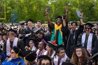 Students celebrate after crossing the stage at Commencement.