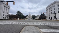 The Alabama State Capitol in Montgomery marks the end of the 1965 Selma to Montgomery voting rights march, commemorated by footprints embedded in the crosswalk.