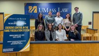 Members of the executive board of the UMass Law review pose in the Moot Court Room.