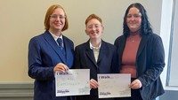 UMass Law students pose with the reason they walk—for equal employment and for access to justice.