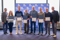 Emma Wood, Dr. Brian Williams, Dr. Mark Altabet, Dr. Kevin Stokesbury, Dr. Chad McGuire, and Dr. Kenneth Manning, joined by Dr. Ramprasad Balasubramanian and Chancellor Mark Fuller for the UMassD Research in the Media Certificate.