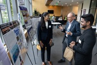 Prof. Daniel MacDonald and his graduate students were discussing in front of their poster.
