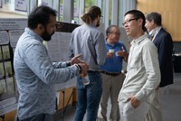 Assistant Prof. Hangjian Ling and a student were discussing the student poster.