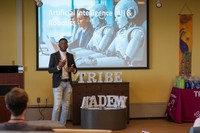UMassD student Gaspard Baye PhD '25 presenting at Tribe, March 2024