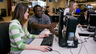 CITS helping student in computer lab