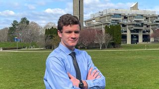 Maxwell White '23, standing in front of the campus quad