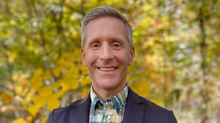 Public Policy Professor Chad McGuire standing outside smiling