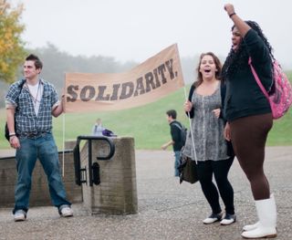 students with sign outside