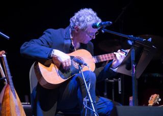 John T. La Barbera plays the guitar