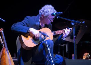 John T. La Barbera plays the guitar