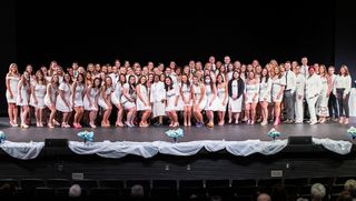 Students gathered on stage with their nursing pins