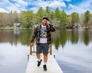 Marcus Howard '19 poses in front of a lake.