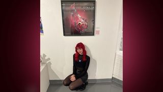 Melissa Antonelli with senior exhibition artwork in the Campus Gallery
