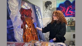 Amanda Driscoll painting at easel in studio