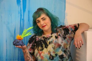 Kate Frazer Rego holding artwork