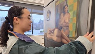 Anna installing work in gallery