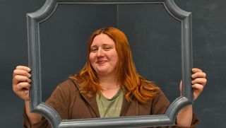 Jillian holding frame in gallery