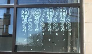 Vinyl mural of tentacles on Star Store window