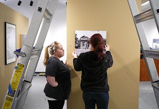 Students hanging work in gallery