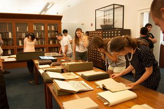 Art History students visit the visual collections of the Whaling Museum archives in New Bedford.