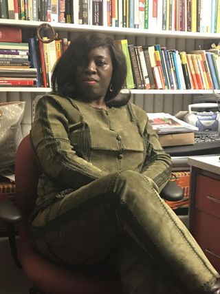 Professor Teboh in her office with books behind her