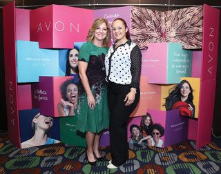 Sheri McCoy '80, CEO of Avon, poses with an Avon representative