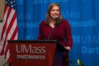 Sofia Reppucci speaking at the podium, MLK Breakfast 2017