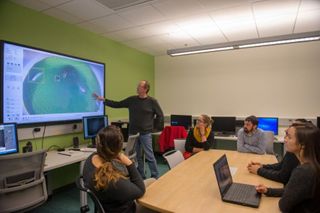 Prof. Stokesbury demonstrates the new SMAST East digitizing lab to students.