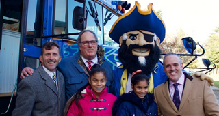 Students and staff pose with Arnie mascot