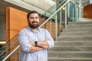 College of Nursing student and U.S. Army veteran Ed Collins standing in Library staircase