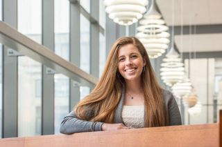 Mary Brown standing in the library