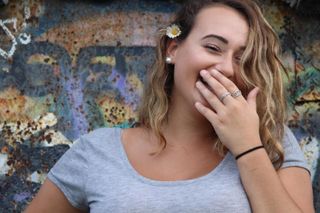 Hailey Angel Allard laughing with her mouth covered