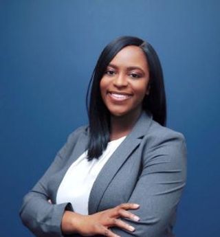 Laurie Senat, JD '21 standing with arms folded