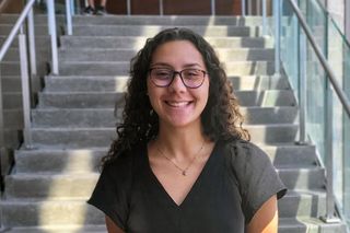 Mechanical engineering student Gabriella Monico in front of the library steps