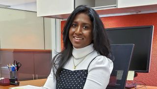 graduate student teacher Merin Bosco seated at her desk