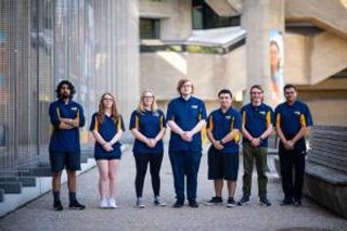 Students in the Engineering Ambassadors group standing in a row outside the library