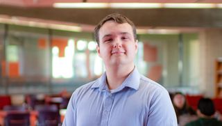 Joshua Keith pictured in the Claire T. Carney Library