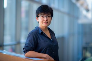 Dr. Ruolin Zhou standing in the UMassD library
