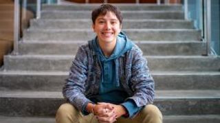 Bee Greenberg seated on library stairs