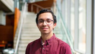 Senior history major Henrique Melo '23 pictured in the Claire T. Carney Library.