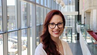 Kathryn Grande '23 pictured in the Claire T. Carney Library