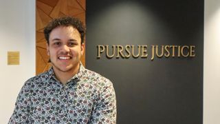 UMassD senior and UMass Law 1L Nathan Upchurch stands in front of the 