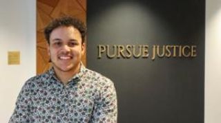 UMassD senior and UMass Law 1L Nathan Upchurch stands in front of the 