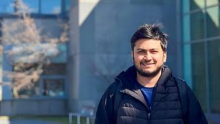 Rahul Chaube stands outside the Charlton College of Business