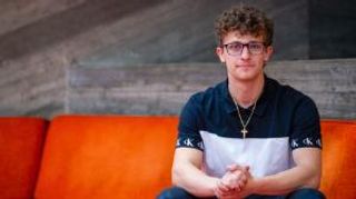 Christopher Brunette sitting in the library