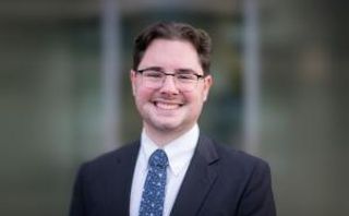 Marshall MacDonald smiling, wearing a suit